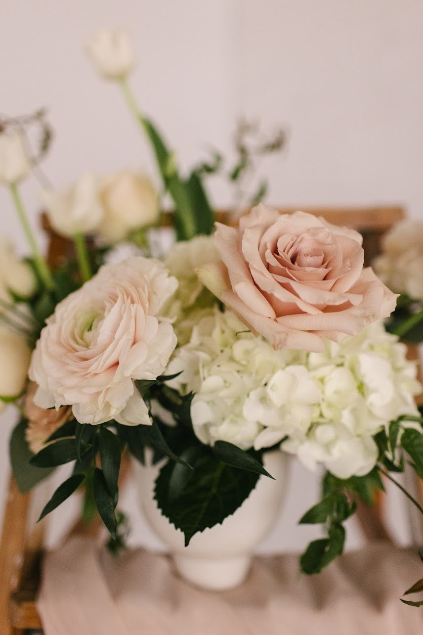 Romantic, garden-inspired florals in a ceramic vessel.