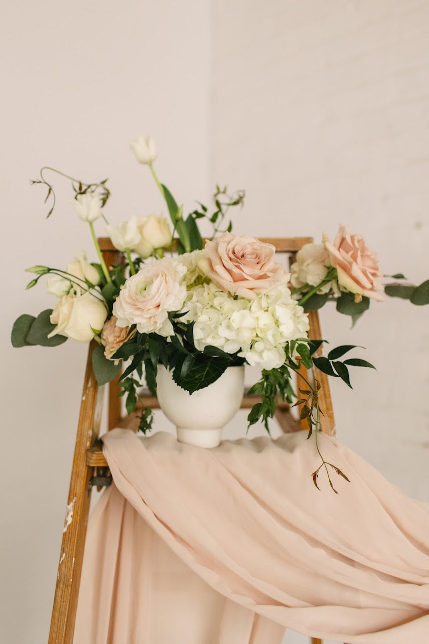 Romantic, garden-inspired florals in a ceramic vessel.