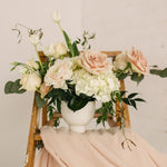 Romantic, garden-inspired florals in a ceramic vessel.